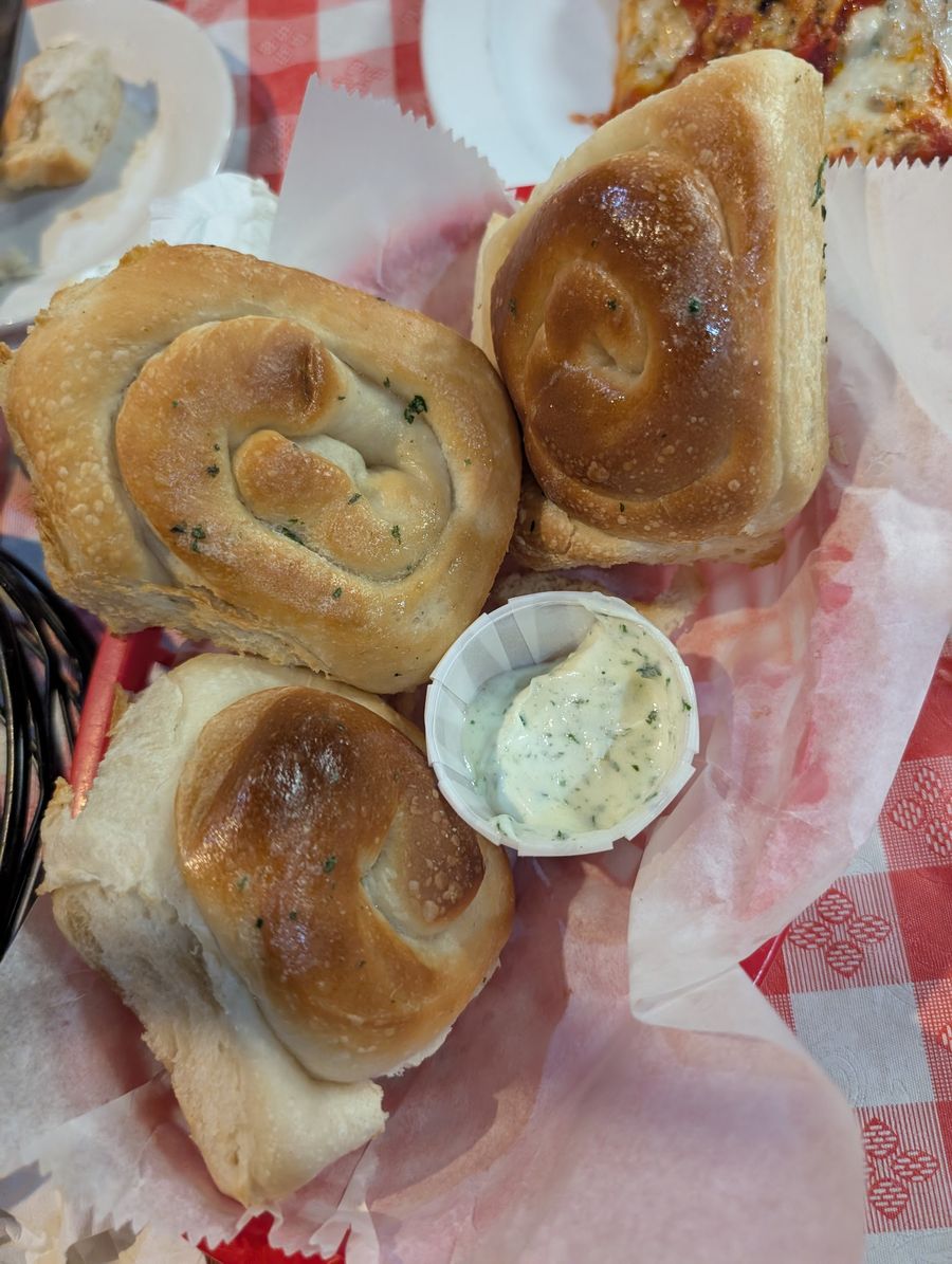 Freshly baked garlic knots with garlic butter at Nick's Italian Restaurant