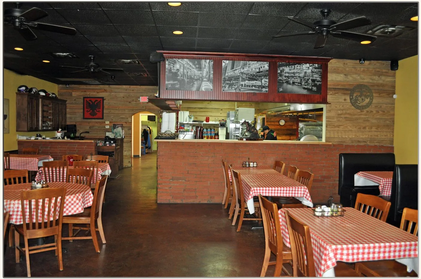 Inside Nick's Italian Restaurant: red checkered tables and brick dining room